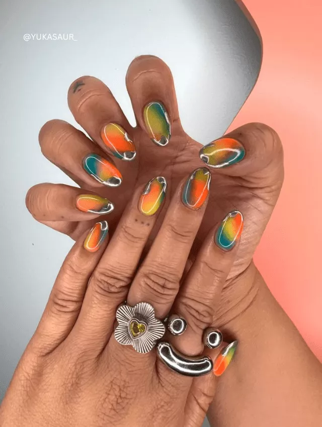 Multi-color neon nails with blooming chrome accents.