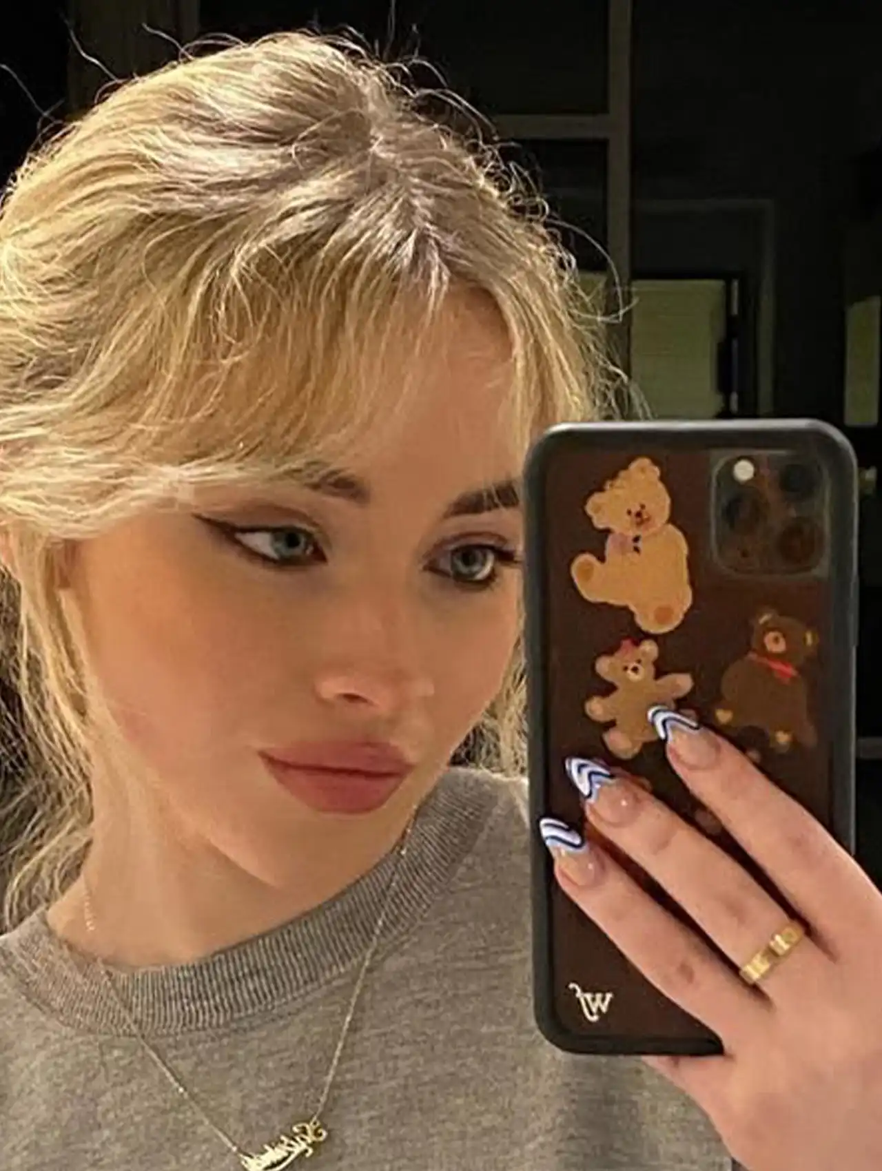 Sabrina Carpenter nails with blue heart design on nude base