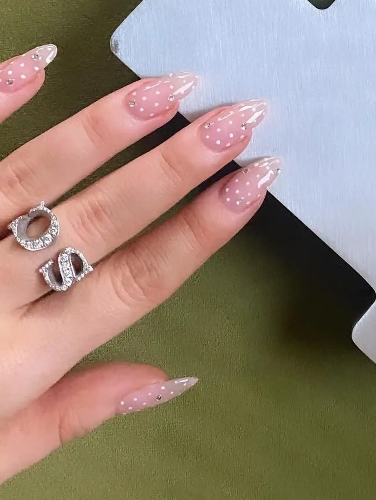 Sabrina Carpenter nails with delicate nude polish and white polka dots