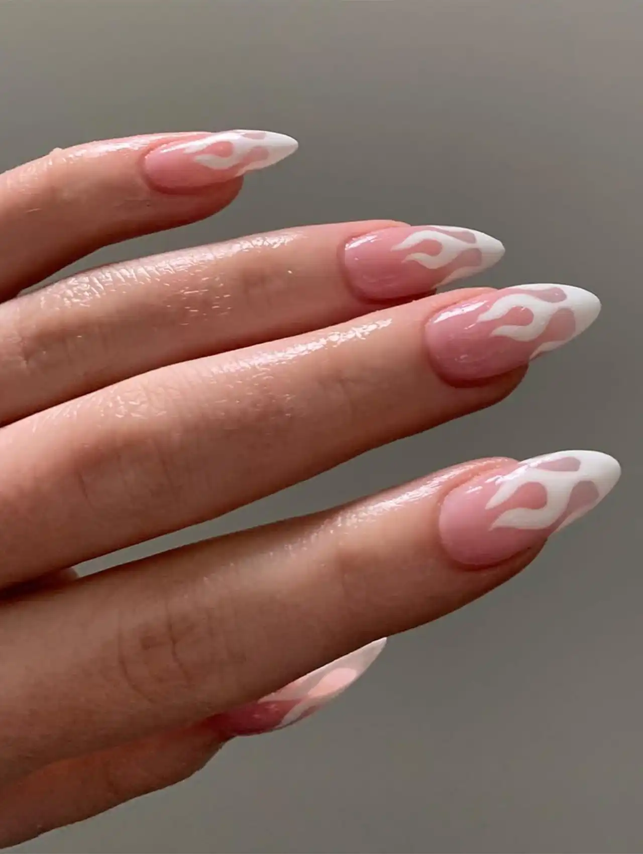 Sabrina Carpenter nails with white flame art on pink base