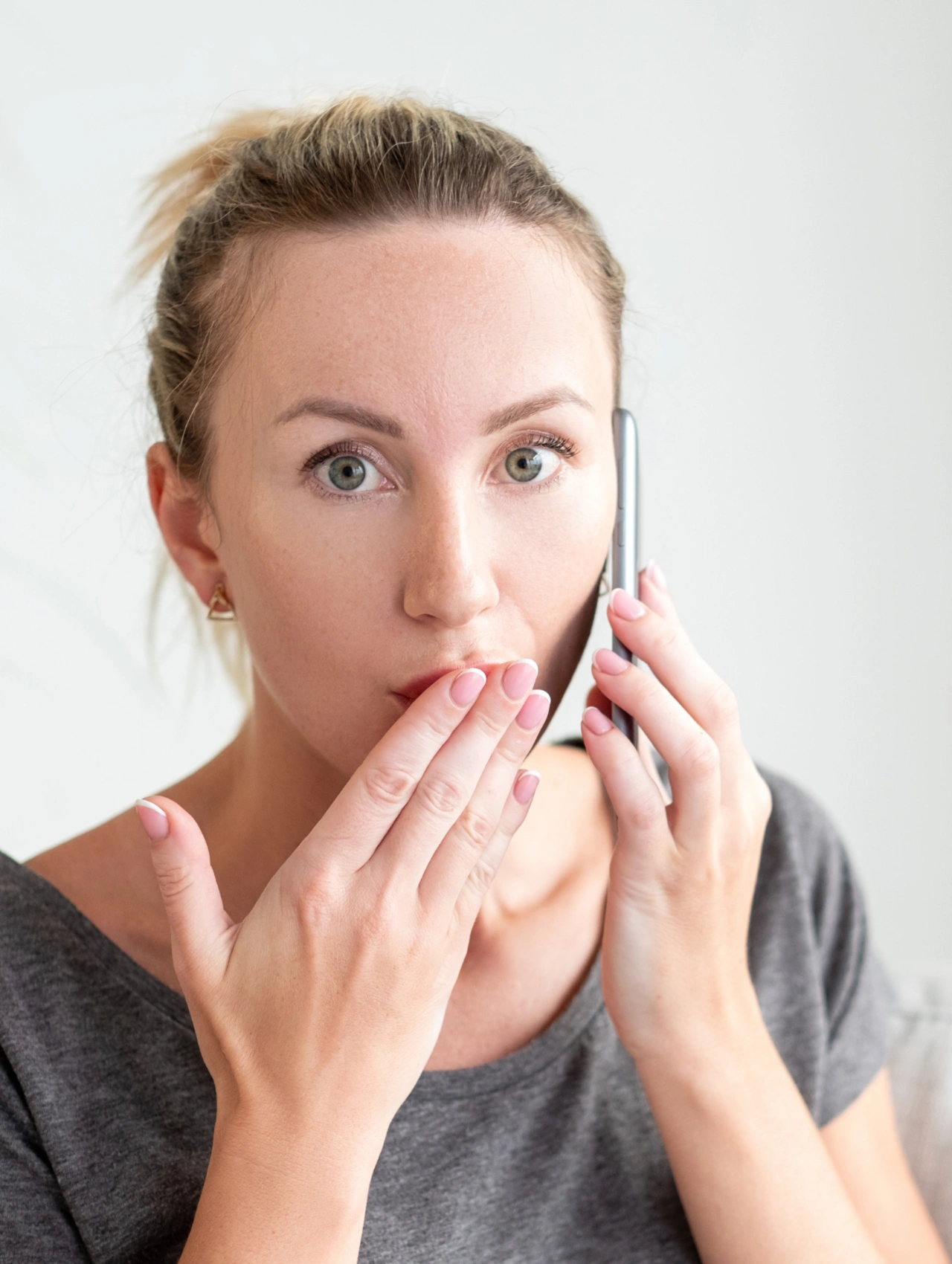 The Accidental Mistress Turned Vengeful Ex Valentine’s Day Date, shocked woman covering her mouth while on the phone during a disastrous Valentine’s Day Date