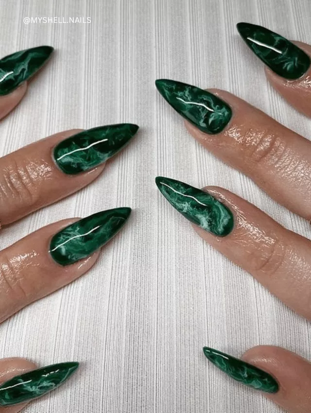Long, pointed emerald green marble nails with a glossy finish.