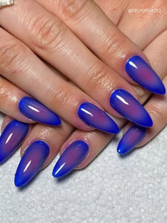  Almond-shaped blue jelly nails with a smooth ombre effect.