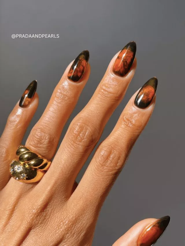 Brown and black smoky marble nails with a high-gloss finish.