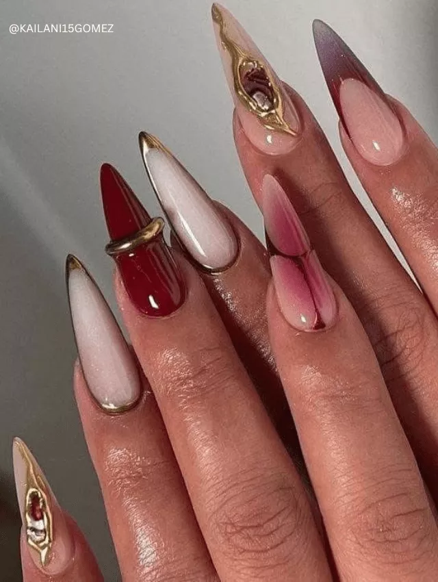 Artistic almond nails with gold 3D accents and burgundy details.