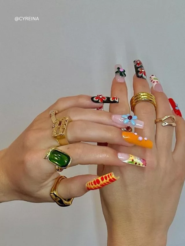 Bold and colorful Y2K-inspired nails with 3D embellishments, florals, and graphic designs.