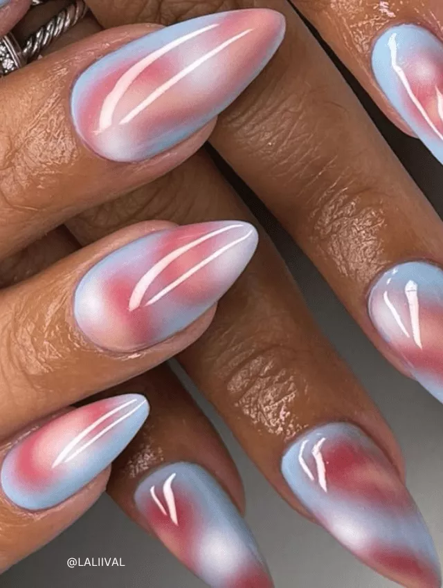 Soft pink and blue marble nails with a pastel ombré effect.