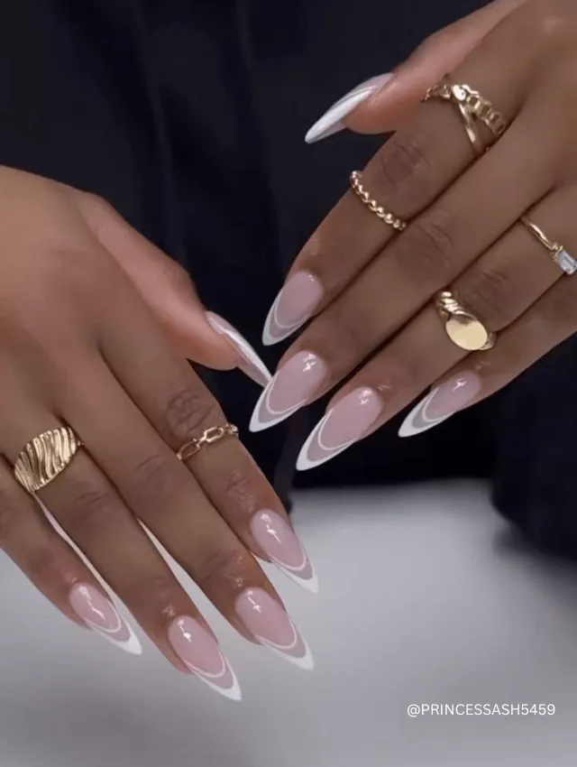 Sharp nude stiletto nails with a crisp white French tip.