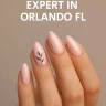 Close-up of pastel pink almond nails with black leaf art on one finger, showing elegant and clean nail design
