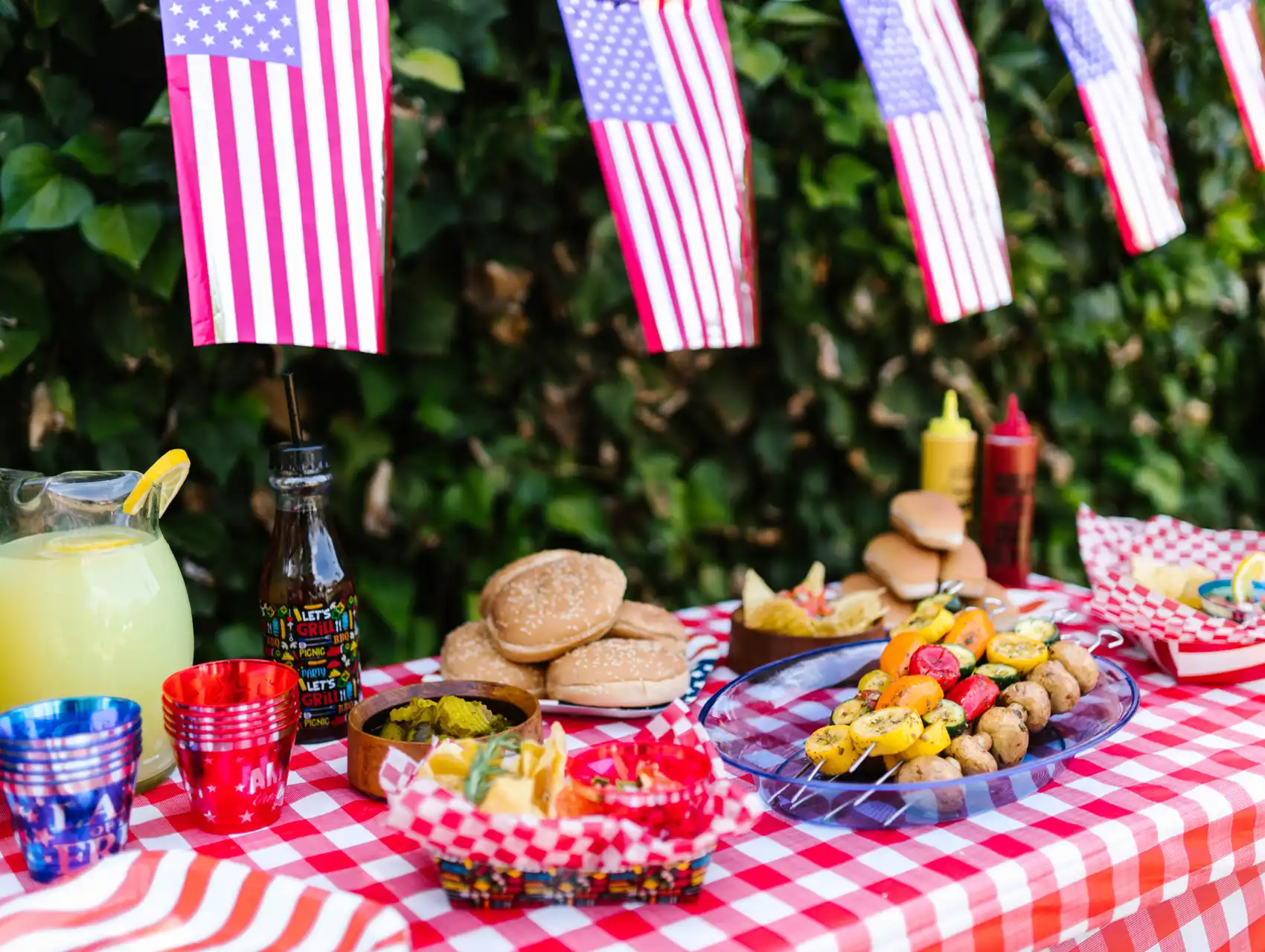 4th of July picnic table in Orlando decorated with American flags and traditional barbecue food