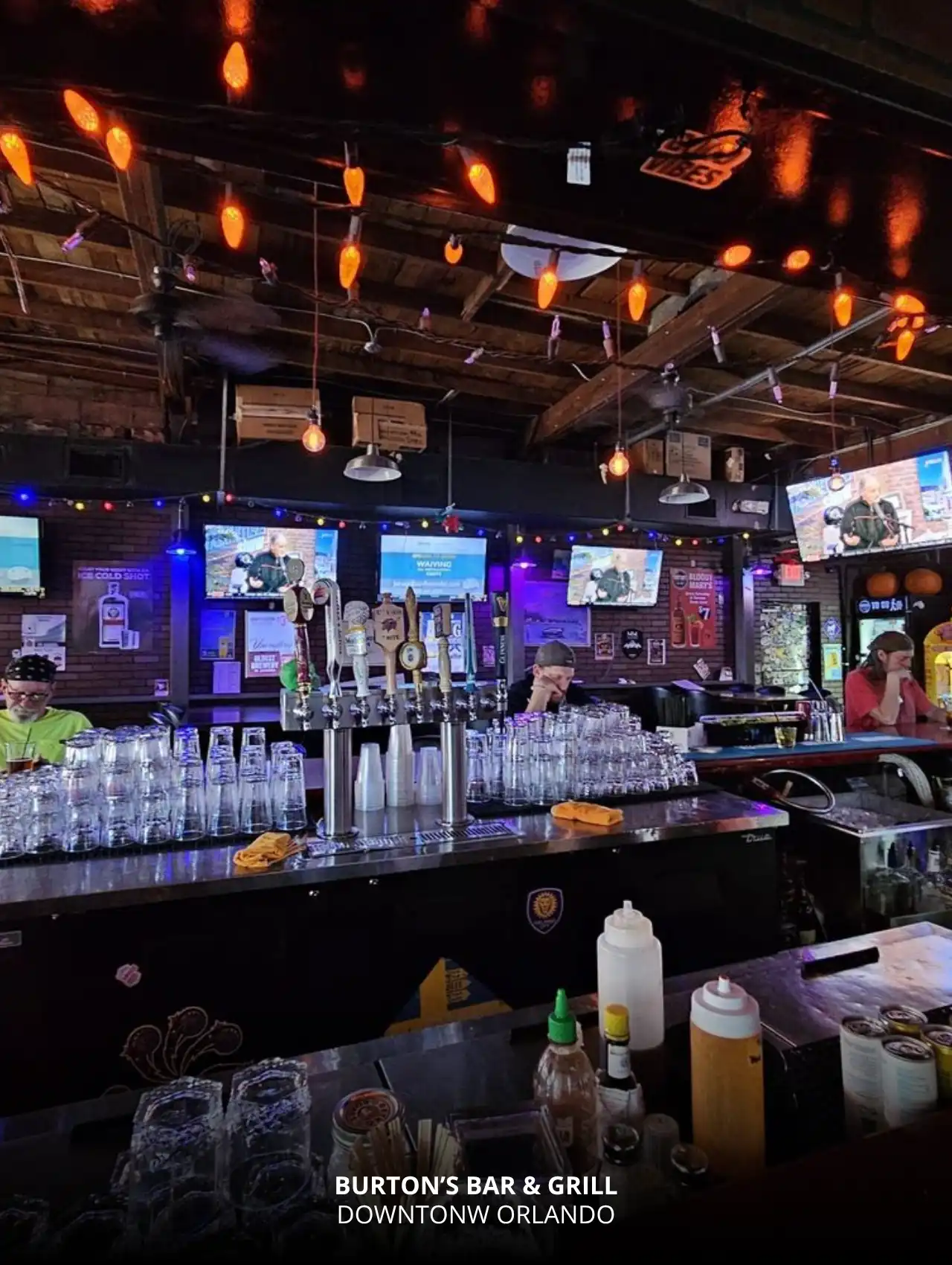 Interior view of Burton’s Bar & Grill with taps and TVs, Downtown Orlando Bars