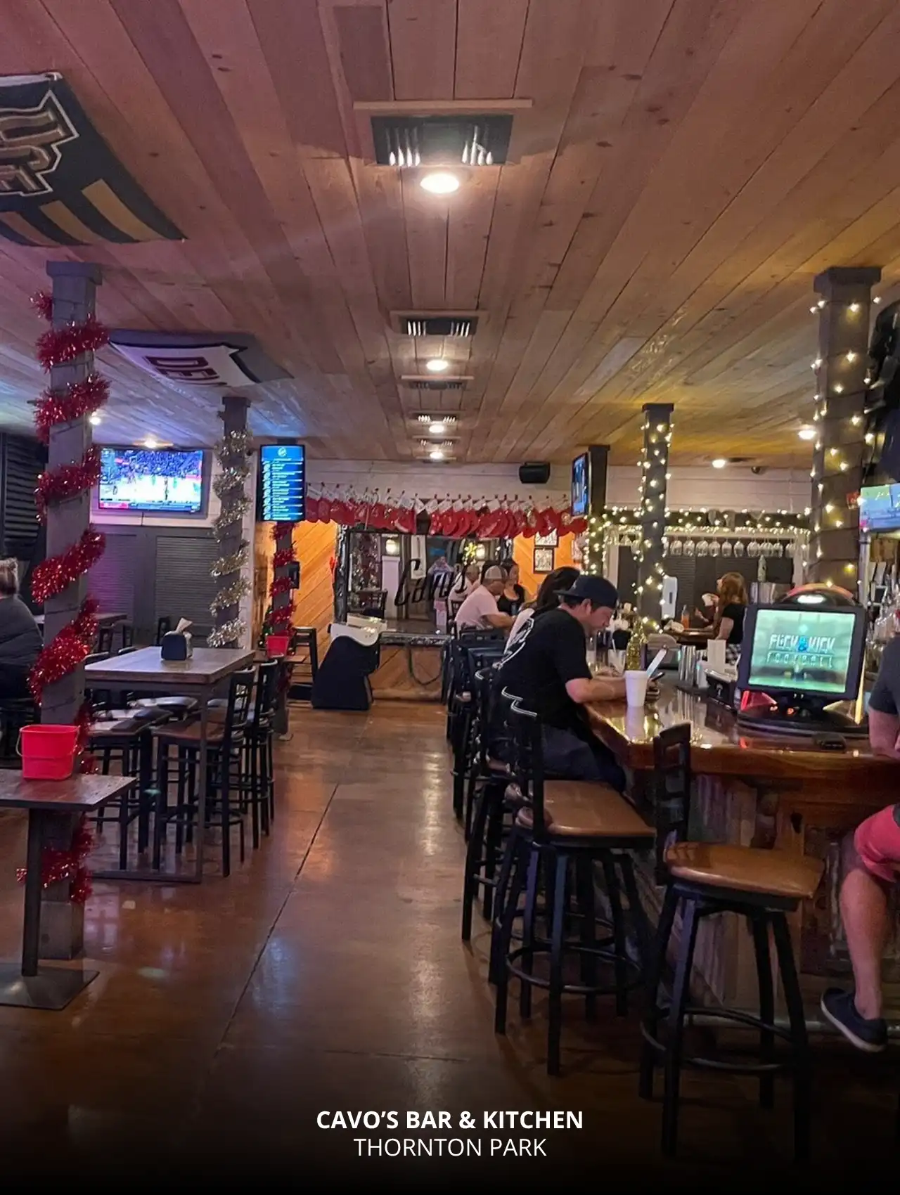 Festively decorated Cavo’s Bar & Kitchen interior with bar seating, Downtown Orlando Bars