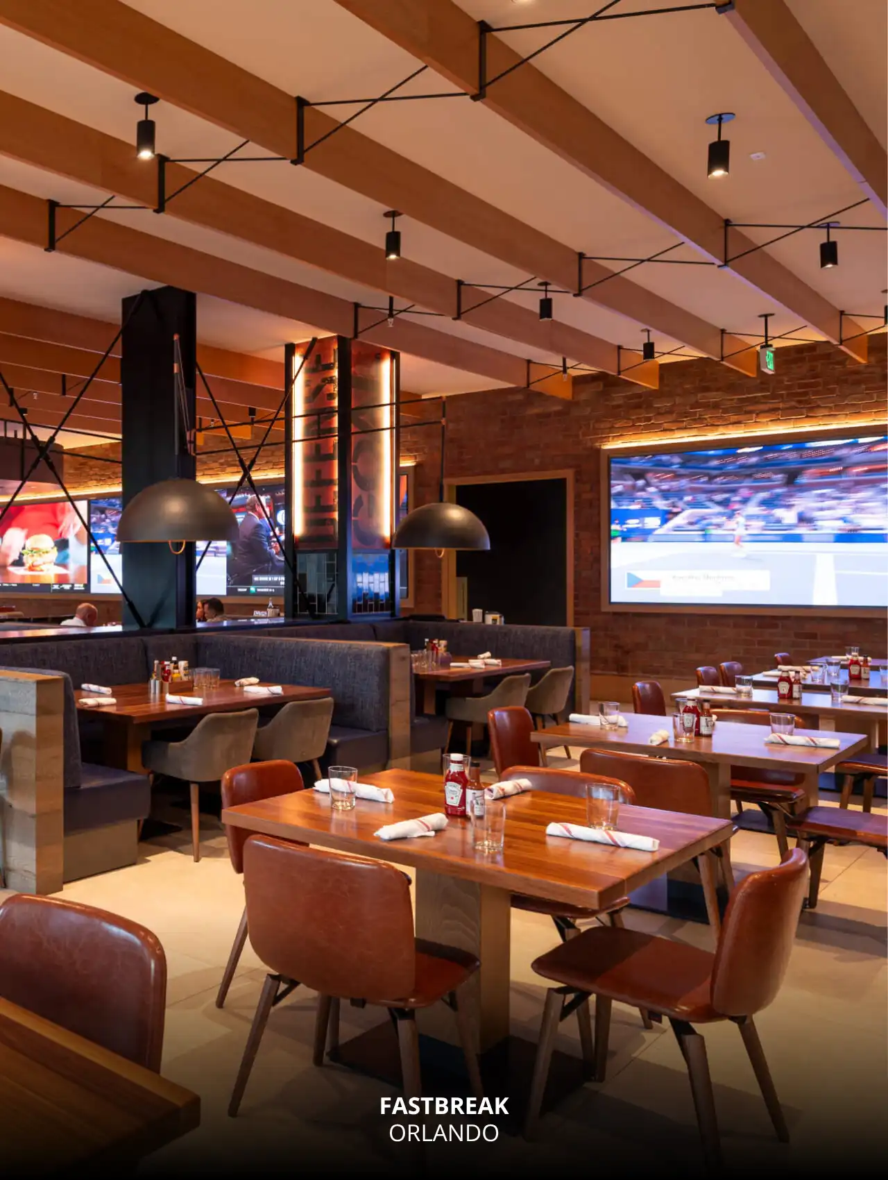 Elegant interior view of Fastbreak restaurant with large screens showing sports, Orlando Sports Bars