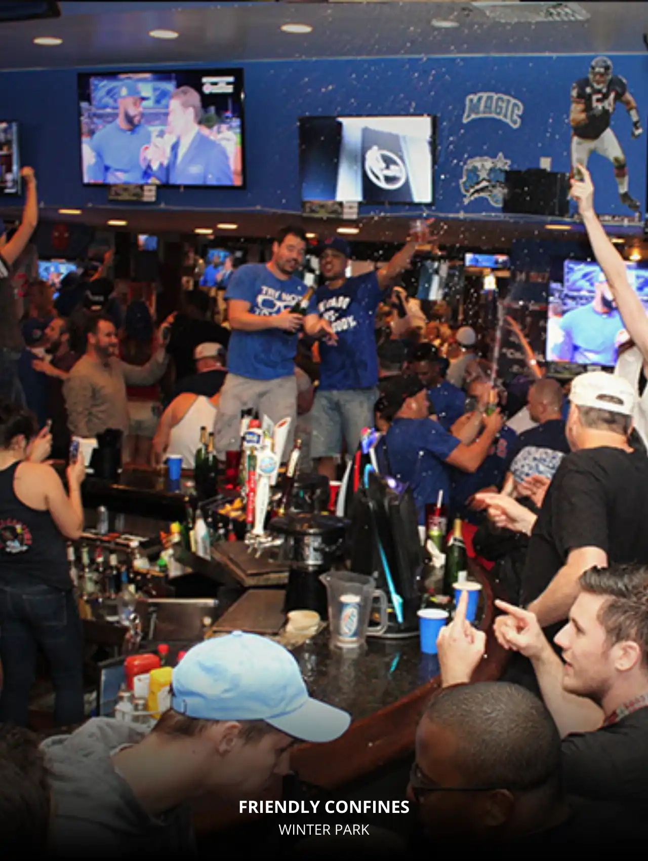 Crowded scene at Friendly Confines in Winter Park with fans celebrating, Orlando Sports Bars