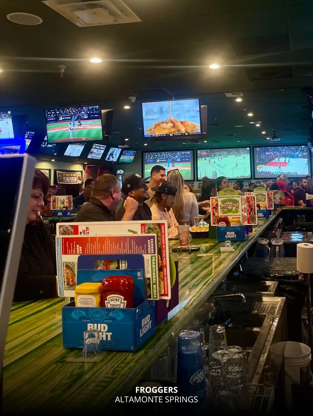 Packed bar and multiple TV screens at Froggers in Altamonte Springs, Orlando Sports Bars