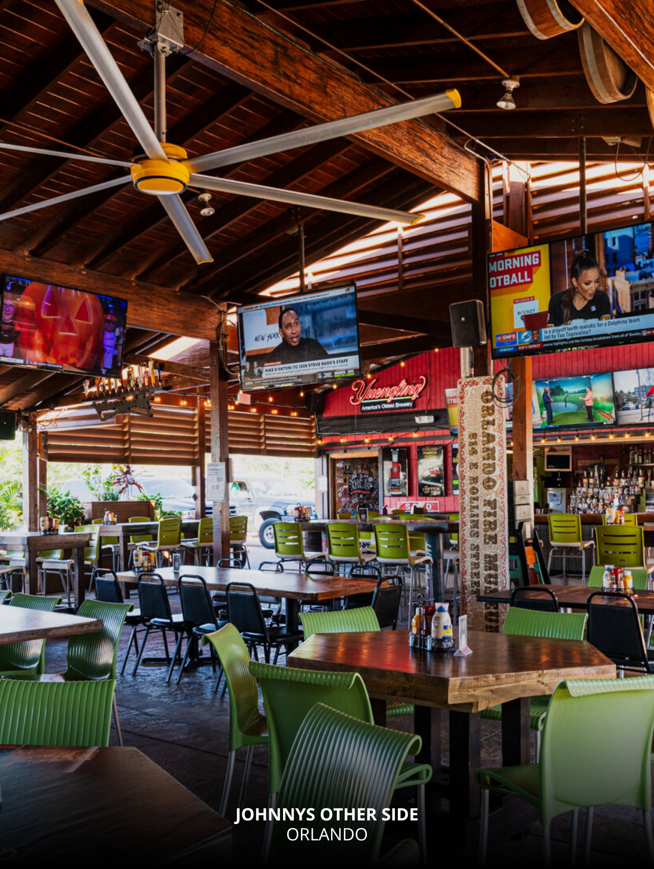 Open-air bar with TVs and wood décor at Johnny’s Other Side, Orlando Sports Bars