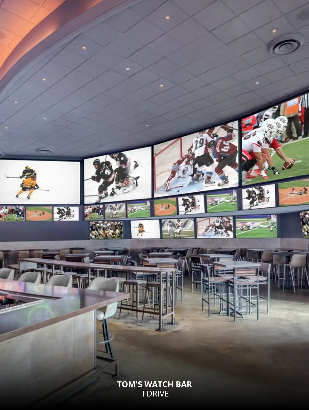 Massive screen wall showing live sports at Tom’s Watch Bar, Orlando Sports Bars