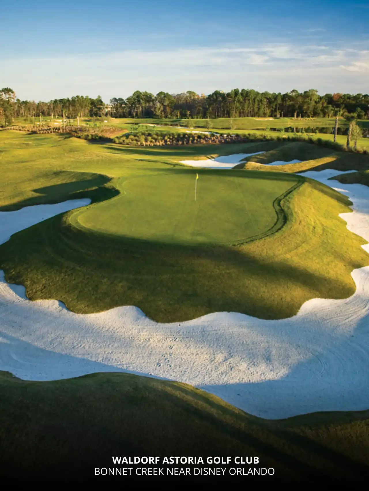 Elevated green surrounded by sand bunkers at Waldorf Astoria Golf Club, a luxury destination among Orlando golf courses