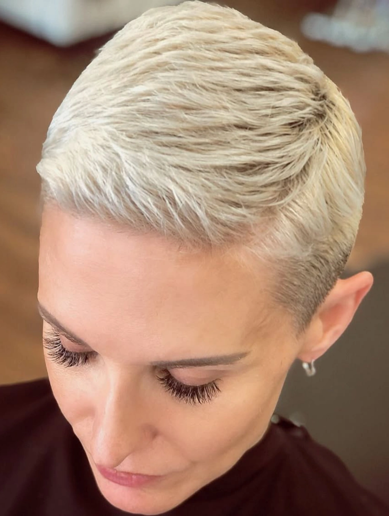 Close-up of Platinum Blonde Pixie Cut Hairstyle with a sleek finish.