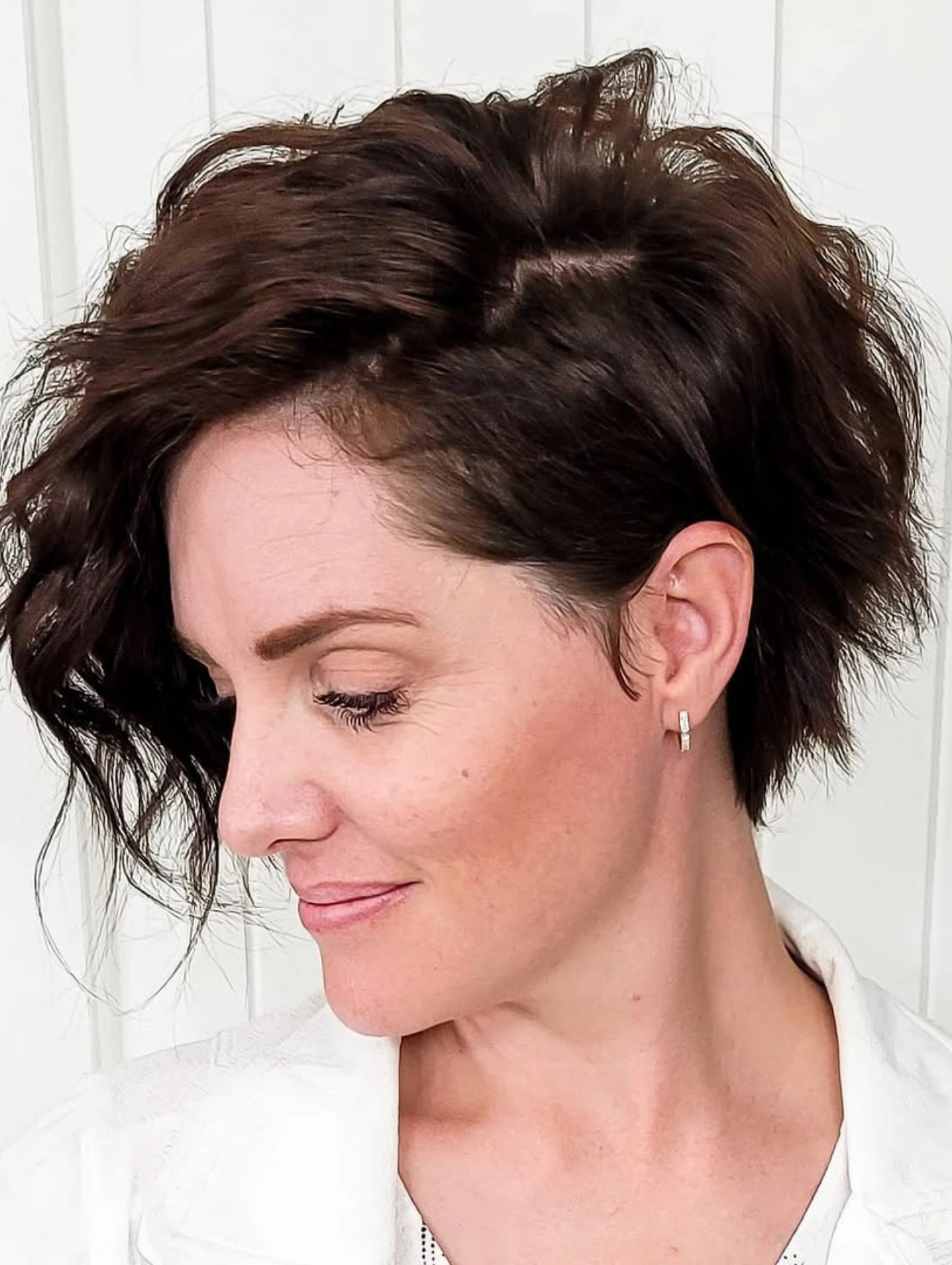Wavy Asymmetrical Pixie Cut Hairstyle with side-swept texture.