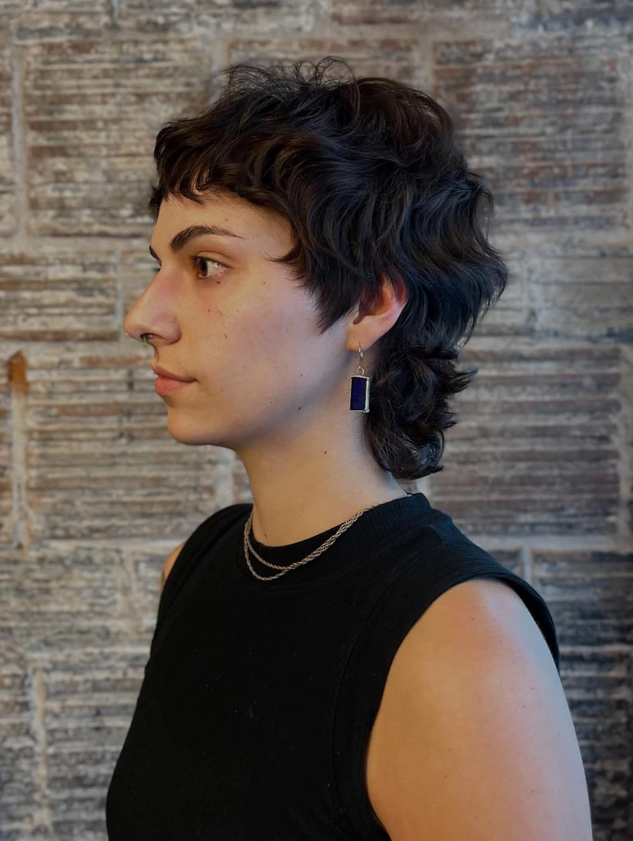 Soft mullet haircut with natural waves and subtle layers, modern mullet hairstyle.