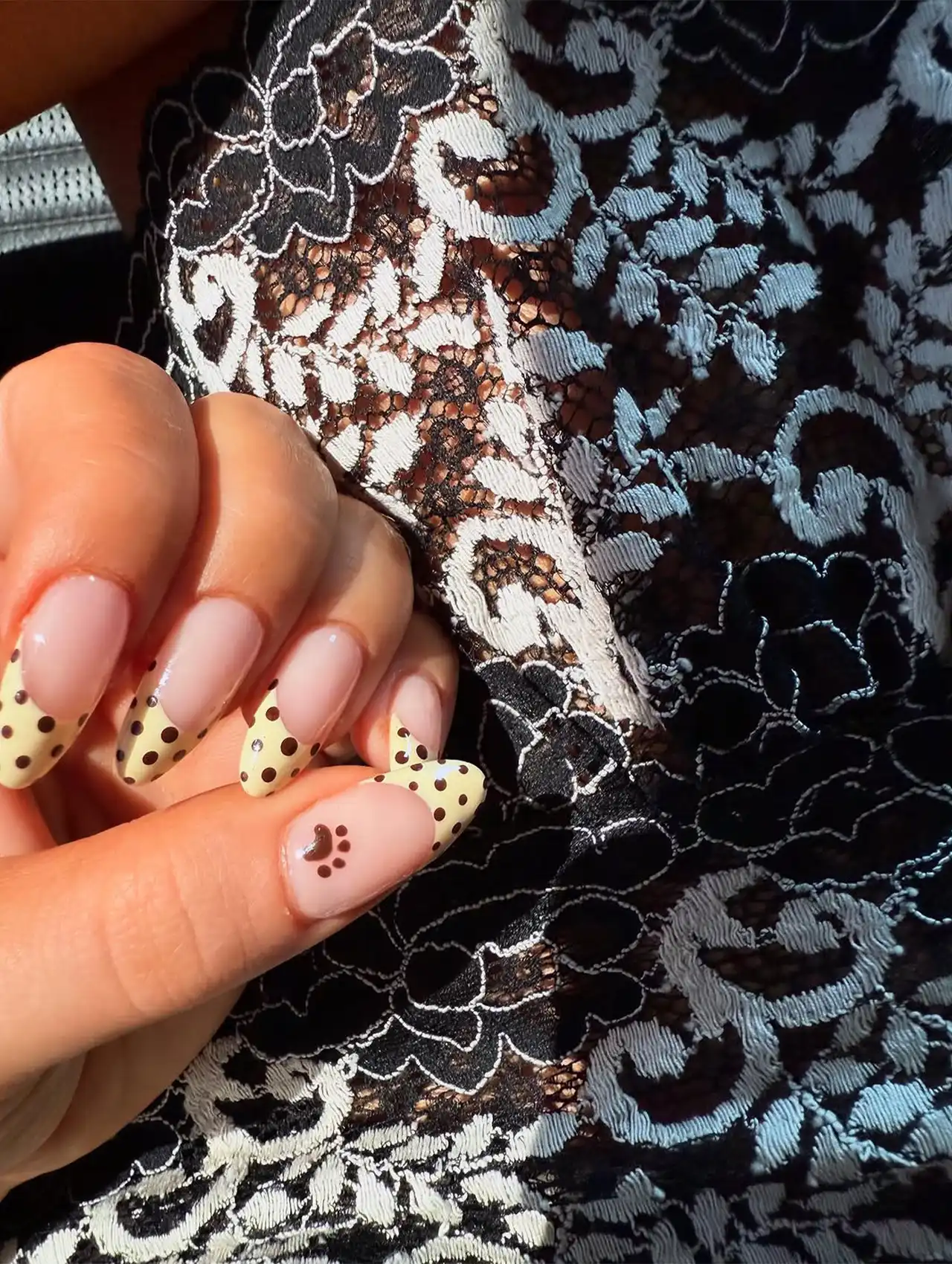 Close-up of Sabrina Carpenter Polka Dot French Tips Nails with nude base and dotted French tips