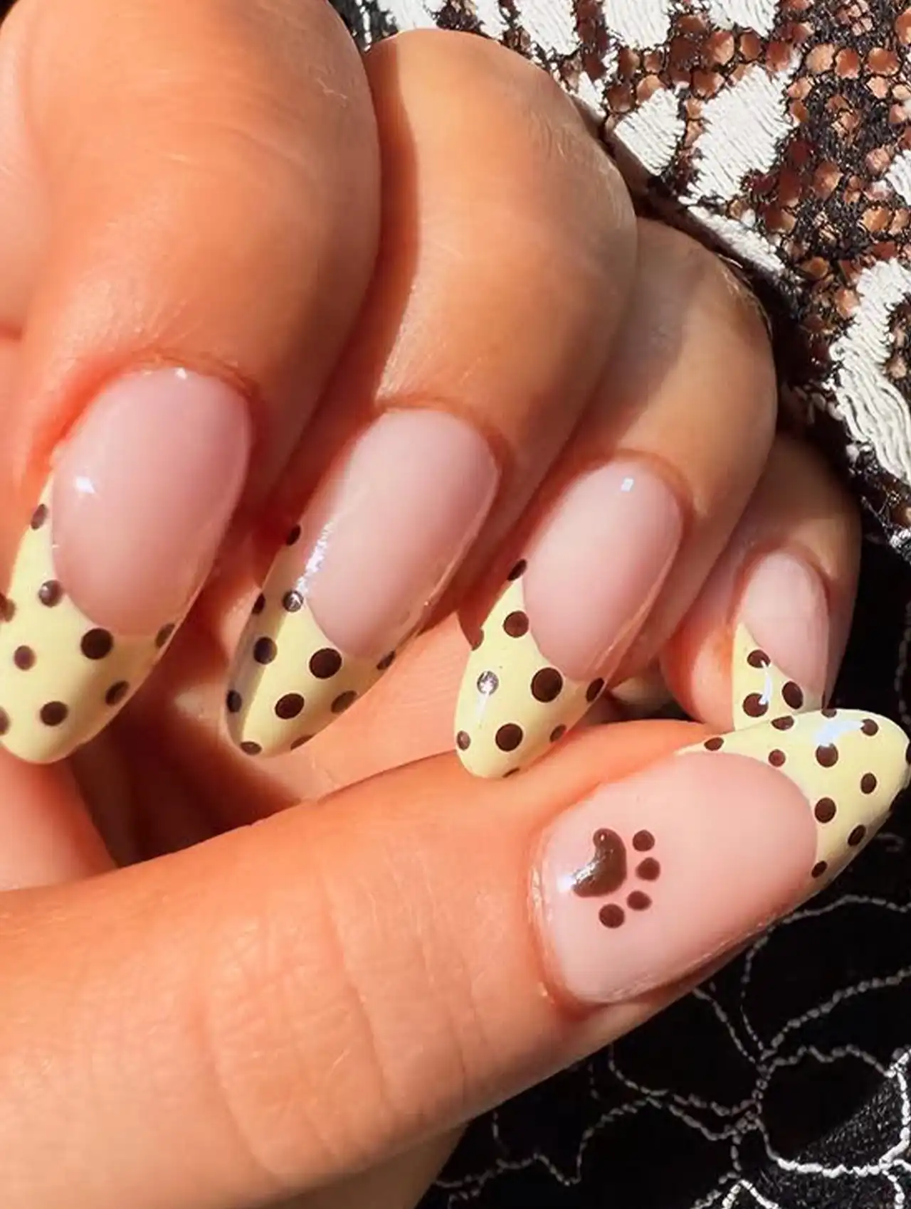 Close-up of Sabrina Carpenter Polka Dot French Tips Nails with yellow and brown dots