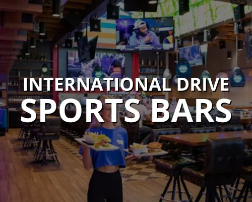 Server carrying burgers and fries at a lively sports bar on International Drive in Orlando with big screen TVs
